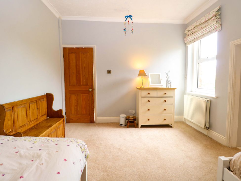A bedroom with a bed and dresser at Tilly's Retreat in Hunstanton
