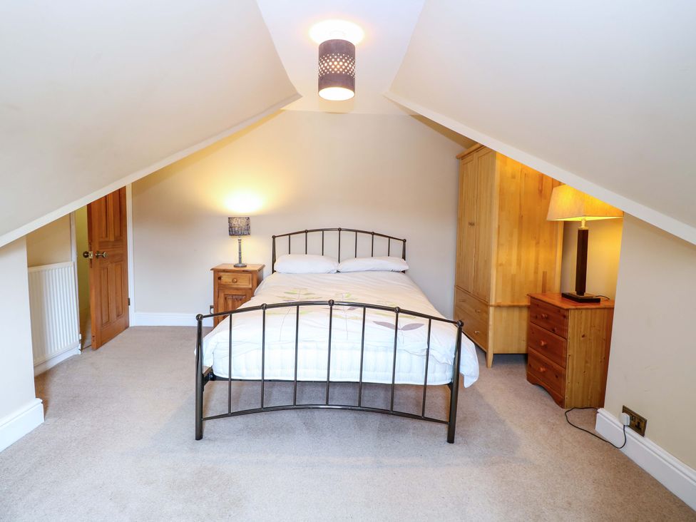 A bedroom with a bed and furniture at Tilly's Retreat in Hunstanton