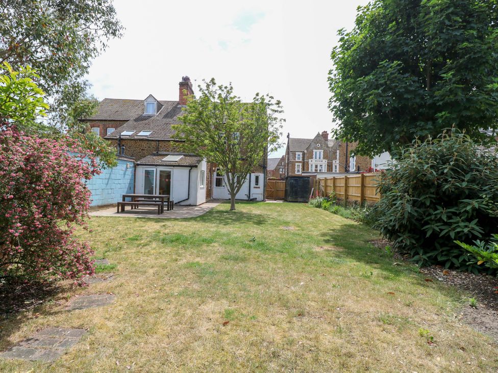 A garden with a table and chairs at Tilly's Retreat in Hunstanton