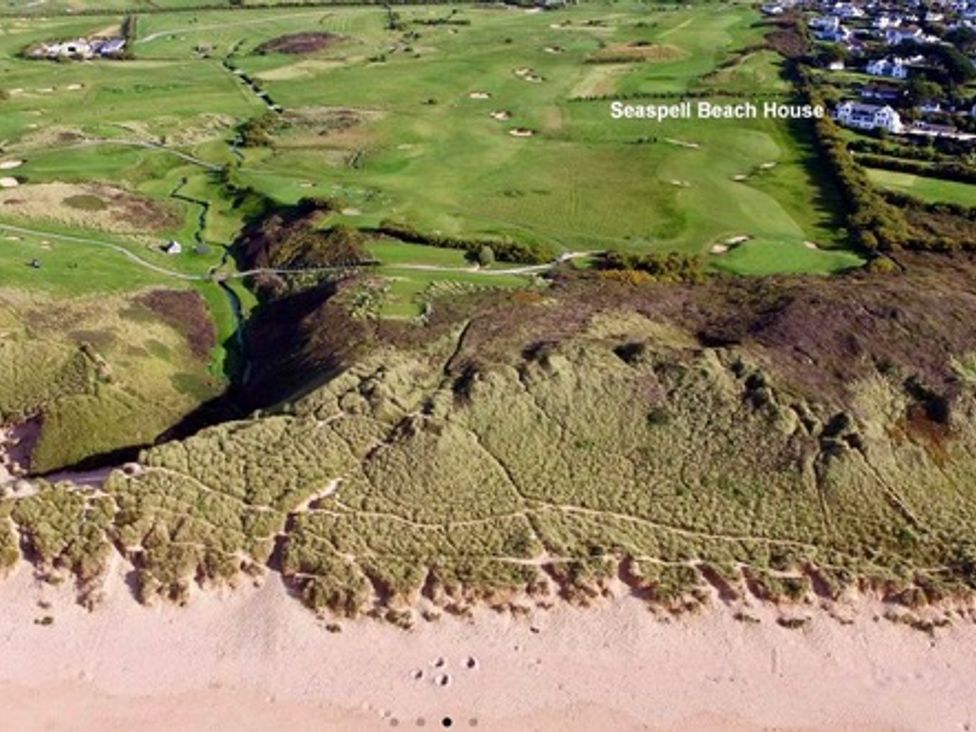An aerial view of a beach and golf course at Seaspell Beach House in Constantine Bay