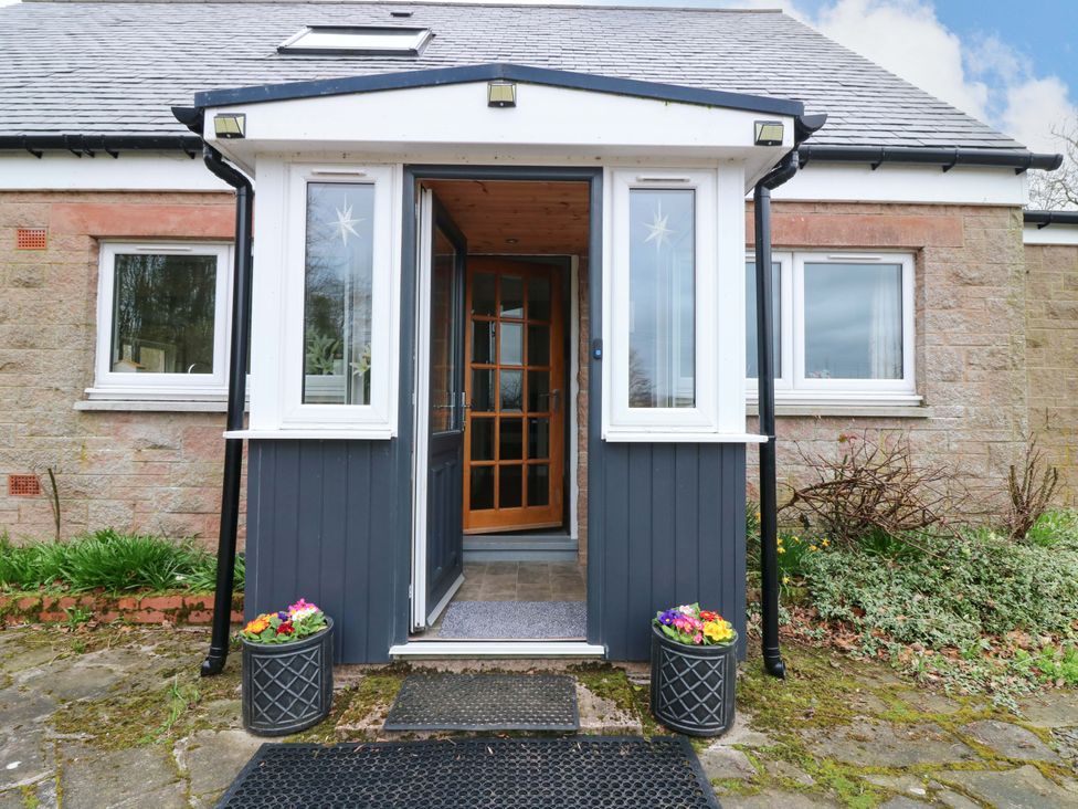 An entrance with a door and windows at Falla Farmhouse in Jedburgh