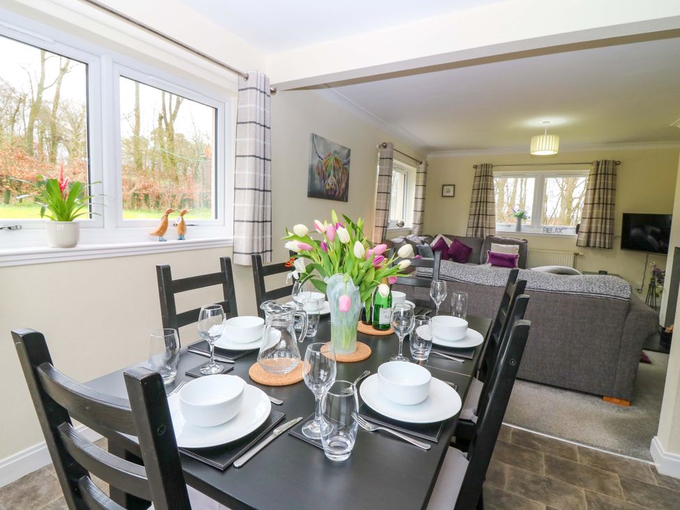 A dining room with a table set for meals at Falla Farmhouse in Jedburgh