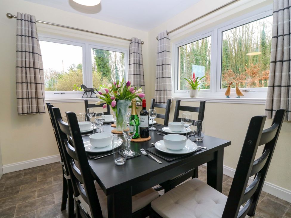 A dining room with a table set for dinner at Falla Farmhouse in Jedburgh