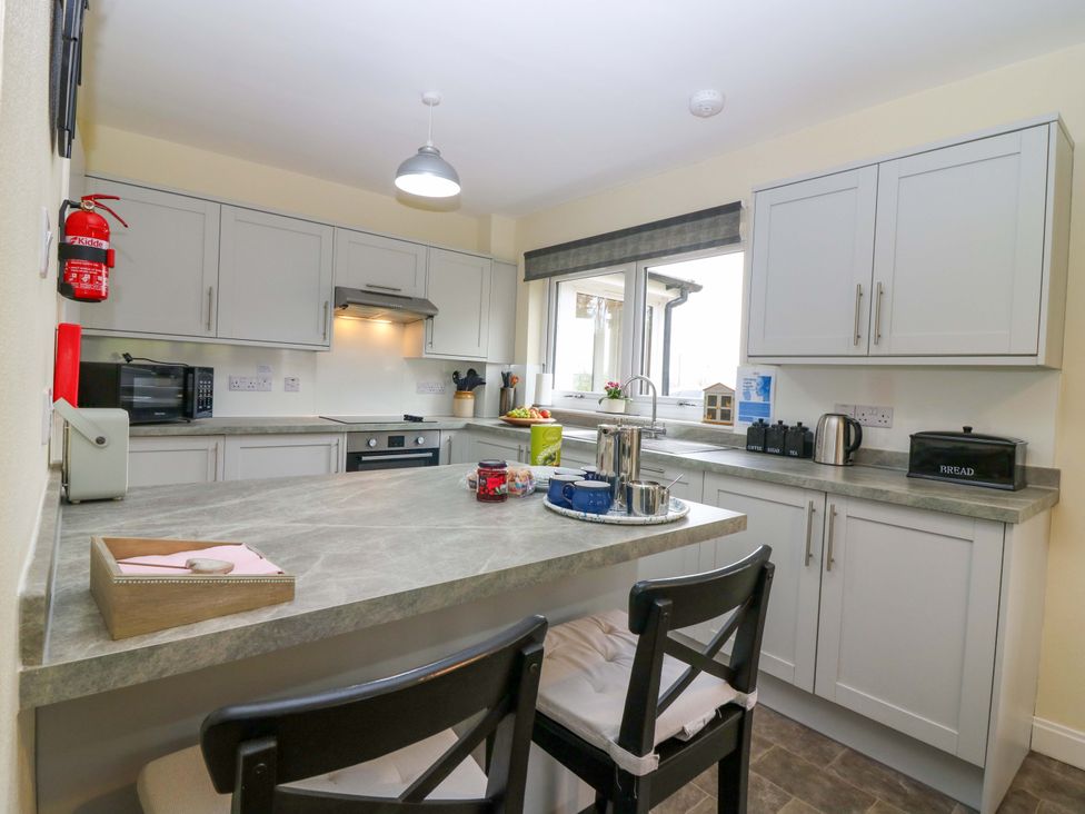 A kitchen with appliances and cabinetry at Falla Farmhouse, Jedburgh