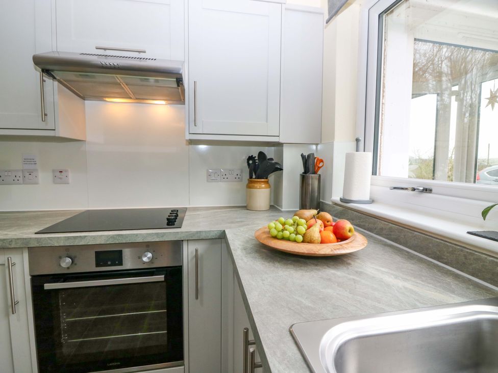 A kitchen with an oven and sink at Falla Farmhouse, Jedburgh