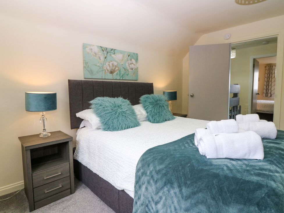 A bedroom with a bed and bedside table at Falla Farmhouse in Jedburgh