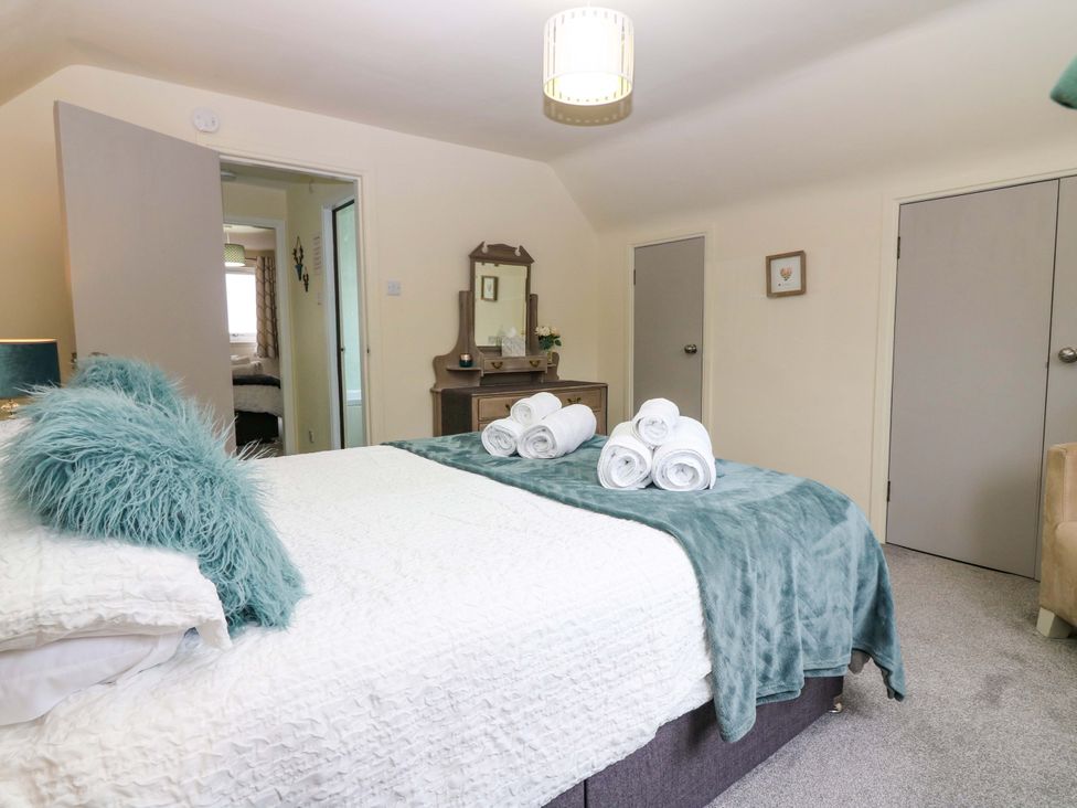A bedroom with a bed and towels at Falla Farmhouse in Jedburgh