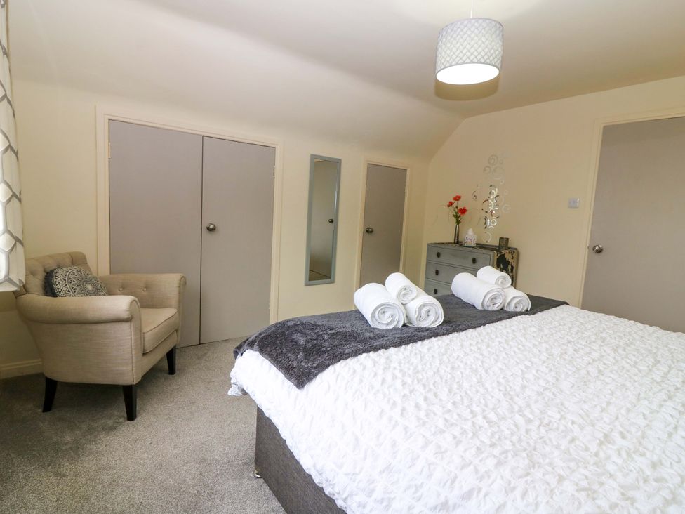 A bedroom with a bed and towels on it at Falla Farmhouse in Jedburgh