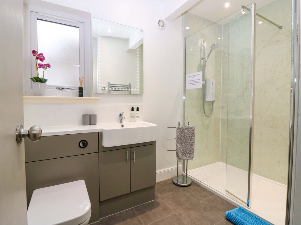 A bathroom with a shower and sink at Falla Farmhouse in Jedburgh