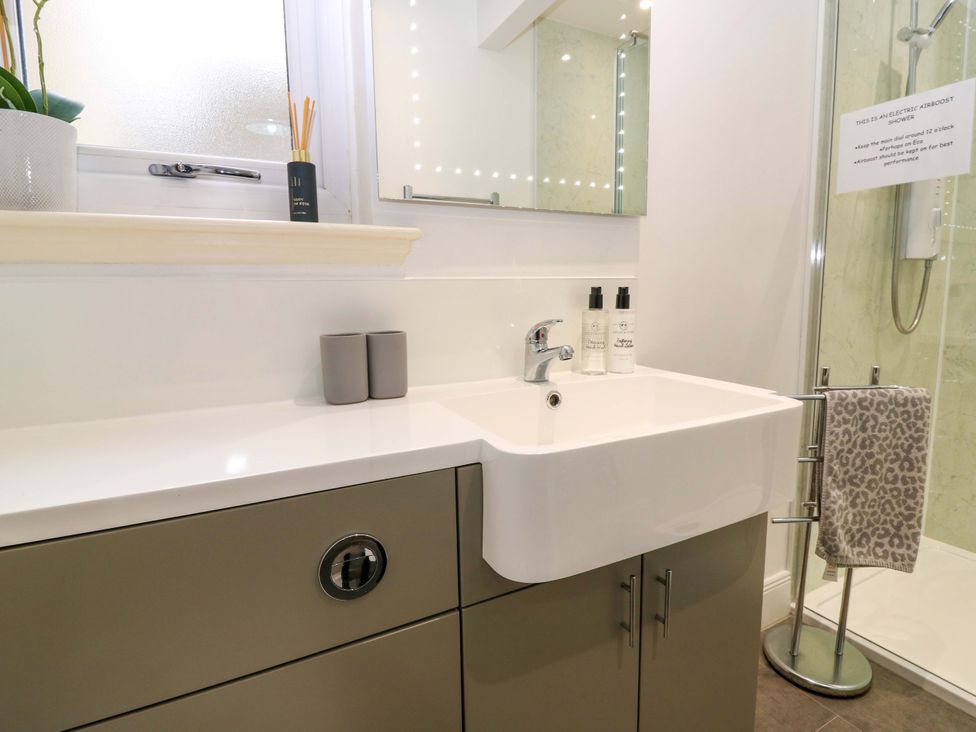 A bathroom with a sink and shower at Falla Farmhouse in Jedburgh