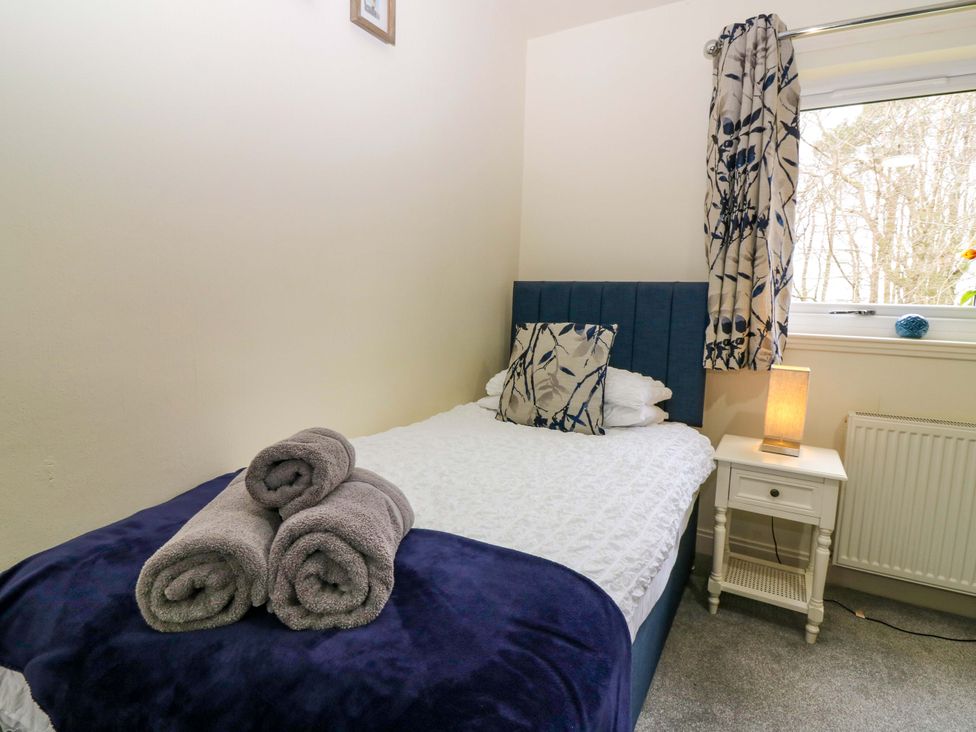 A bedroom with a bed and towels at Falla Farmhouse in Jedburgh