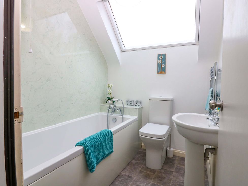 A bathroom with a bathtub and toilet at Falla Farmhouse Jedburgh