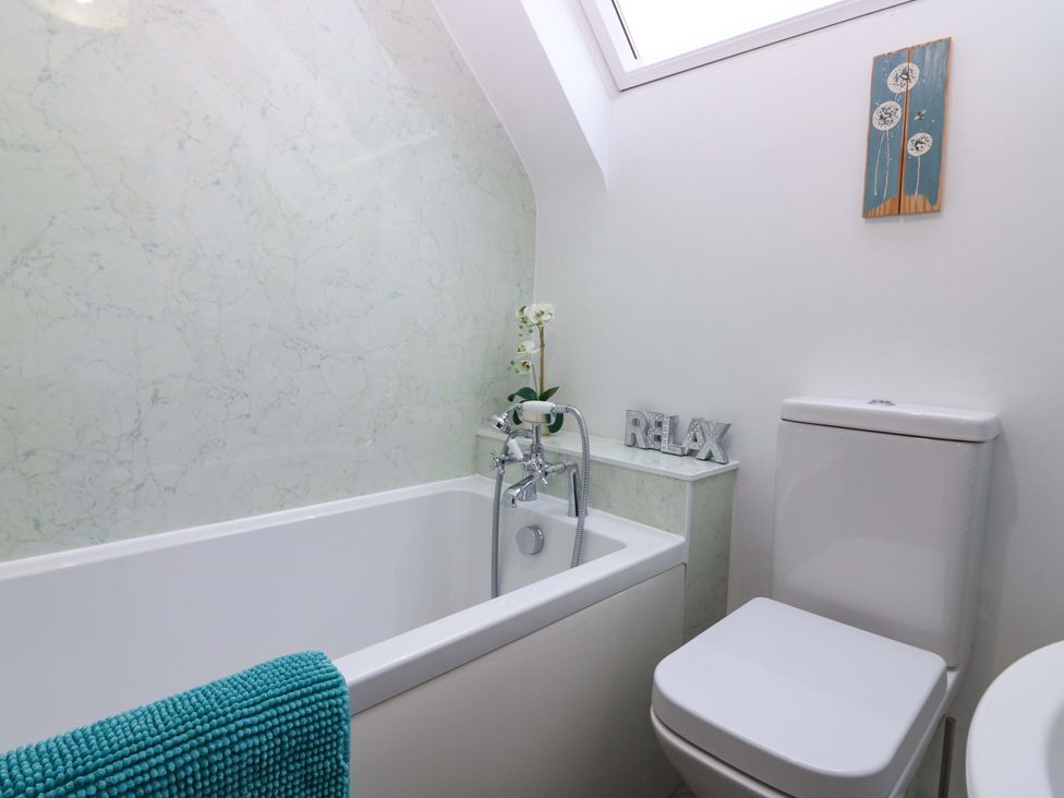 A bathroom with a bathtub and toilet at Falla Farmhouse in Jedburgh