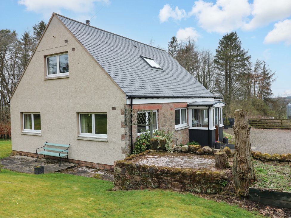A house with windows and a garden at Falla Farmhouse in Jedburgh