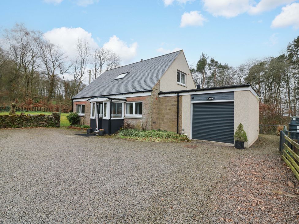 A house with a garage and driveway at Falla Farmhouse in Jedburgh