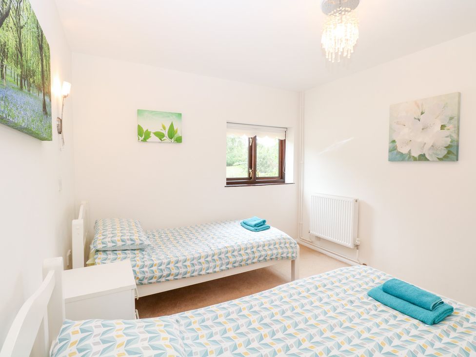 A bedroom with two single beds at Lowbrook Cottage in Dickleburgh near Diss