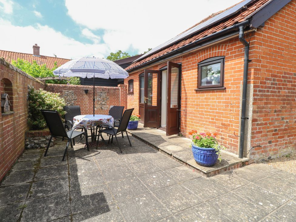 An outdoor seating area with table and chairs at Lowbrook Cottage Dickleburgh near Diss