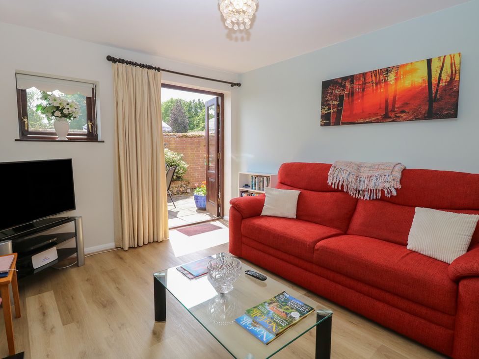 A living room with a sofa and coffee table at Lowbrook Cottage in Dickleburgh near Diss