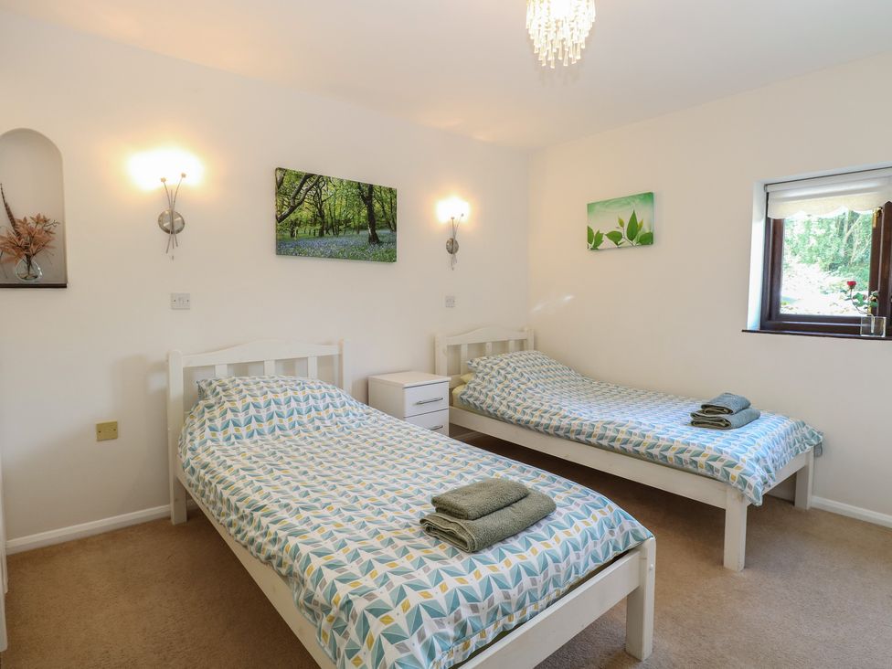 A bedroom with two beds and artwork at Lowbrook Cottage Dickleburgh near Diss