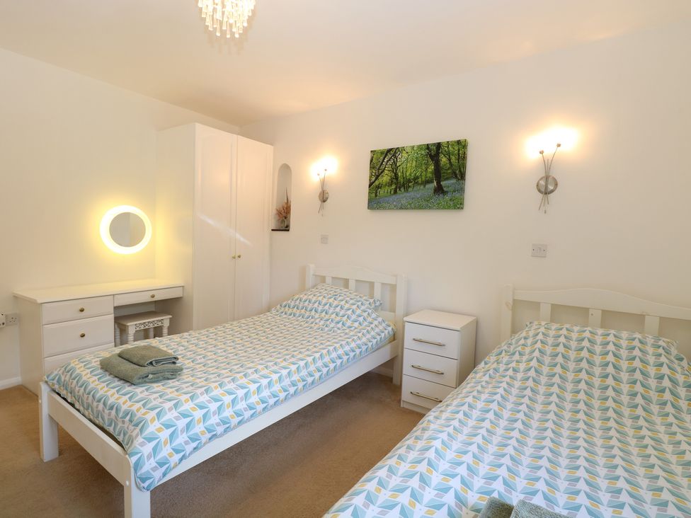 A bedroom with two single beds and a wardrobe at Lowbrook Cottage in Dickleburgh near Diss