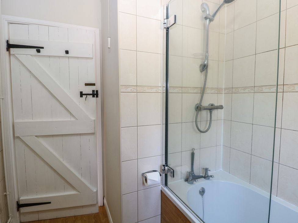 A bathroom with a shower and bathtub at Lowbrook Cottage Dickleburgh near Diss