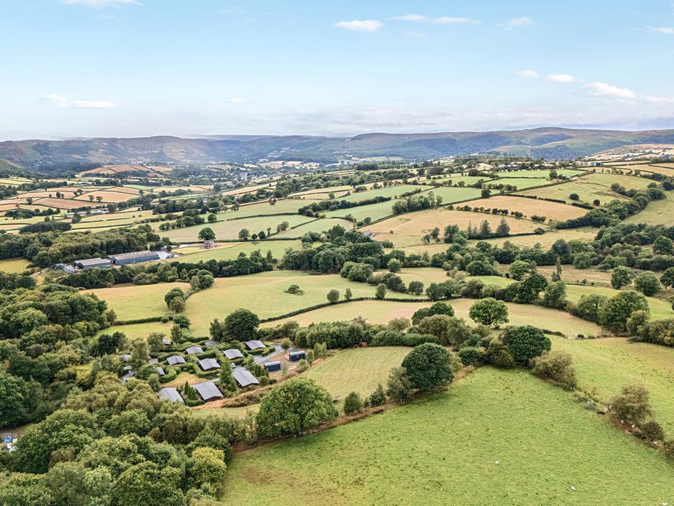 A landscape view with fields and trees at Glanyrafon Bungalow St Harmon