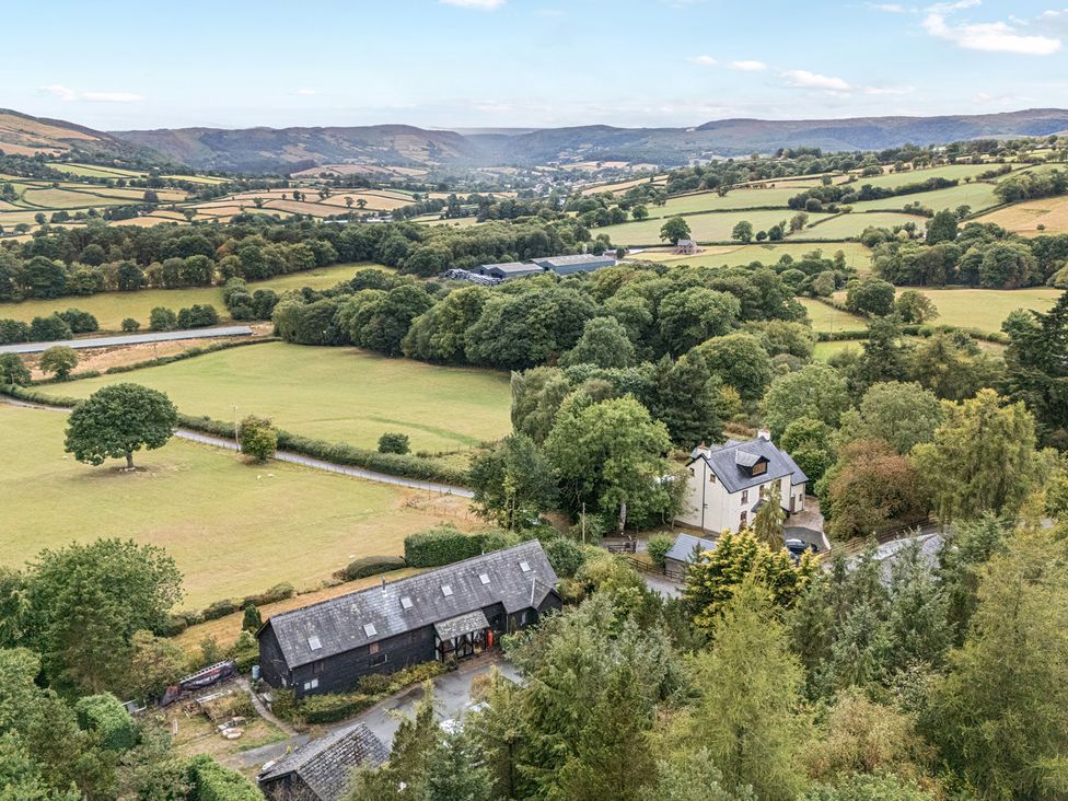 A landscape view of fields and trees at Glanyrafon Bungalow in St Harmon