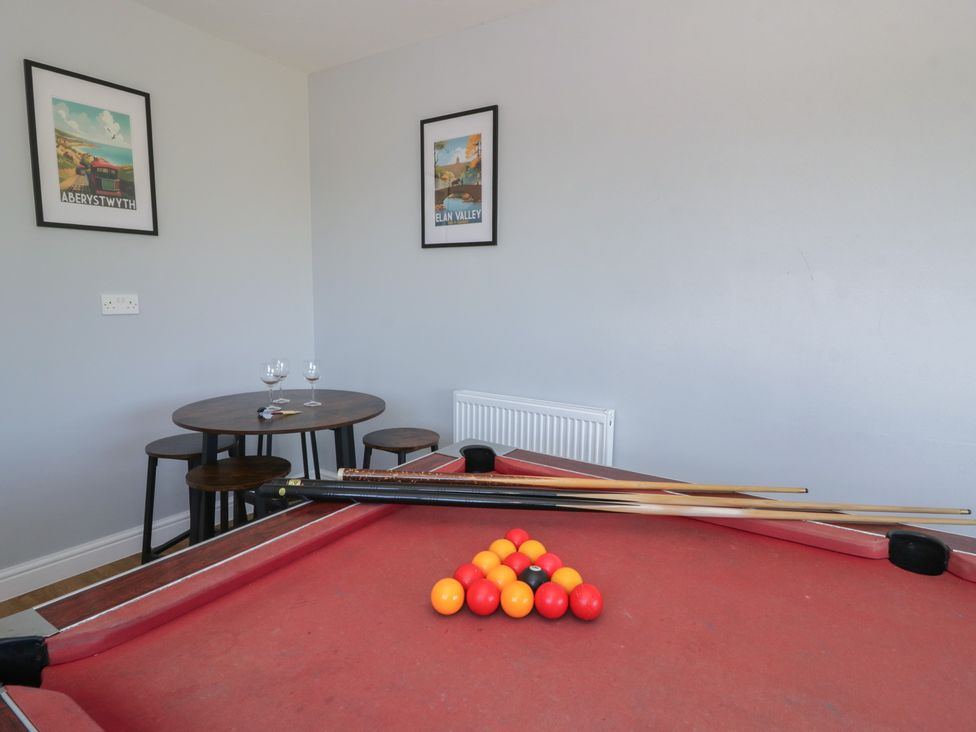 A game room featuring a pool table and a small table at Glanyrafon Bungalow St Harmon