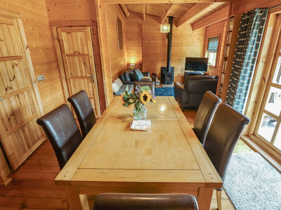 A dining room with a table and chairs at Tythe Lodge – Hot Tub Retreat in Rural Lincolnshire | Family-Friendly Lodge Near Heckington