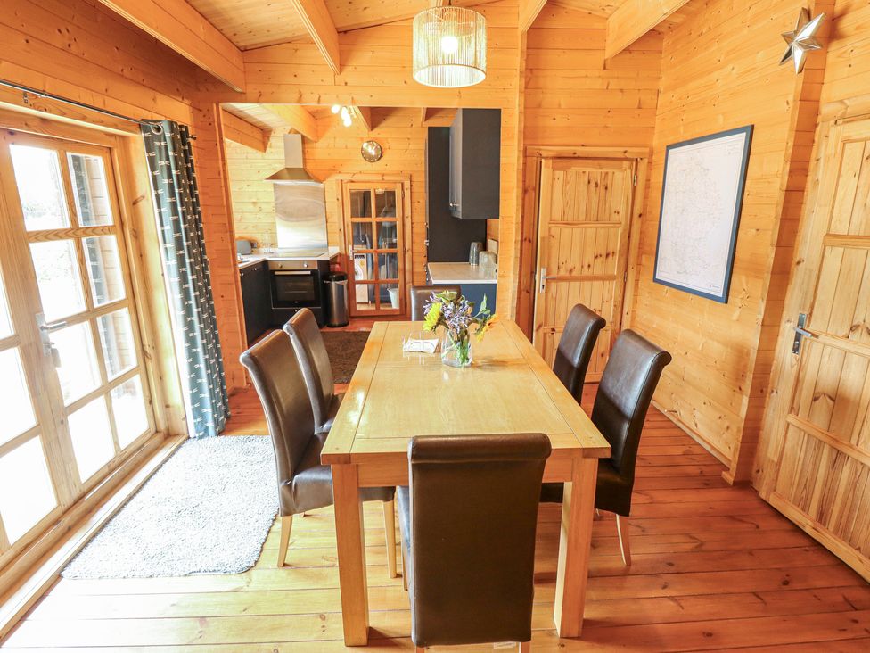 A dining room with a table and chairs at Tythe Lodge – Hot Tub Retreat in Rural Lincolnshire | Family-Friendly Lodge Near Heckington