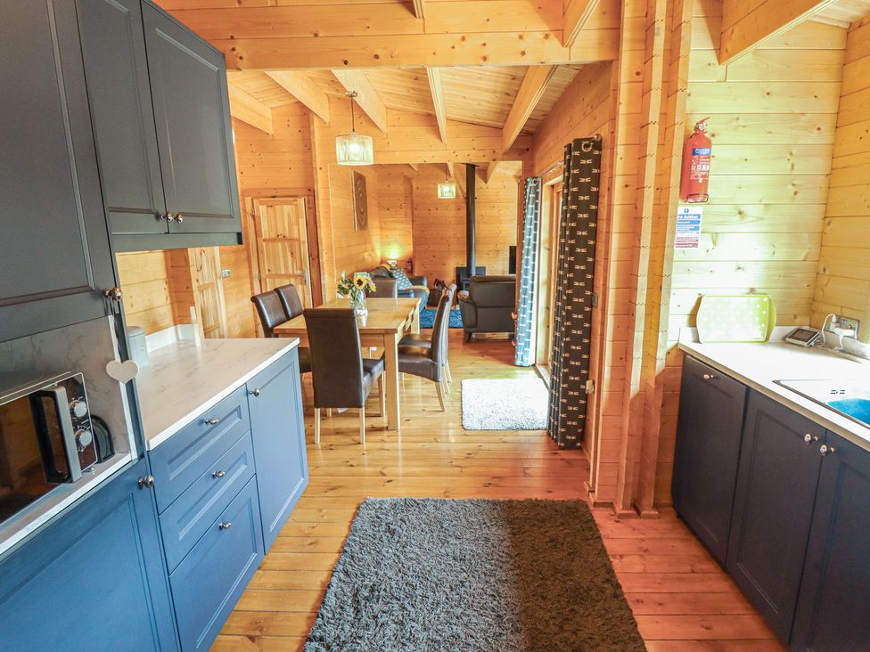 A kitchen with a dining area and seating at Tythe Lodge – Hot Tub Retreat in Rural Lincolnshire | Family-Friendly Lodge Near Heckington