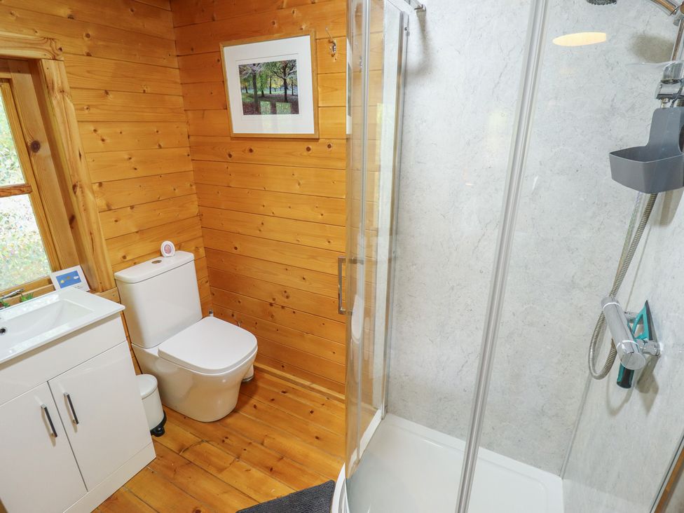 A bathroom with a sink, toilet, and shower at Tythe Lodge – Hot Tub Retreat in Rural Lincolnshire | Family-Friendly Lodge Near Heckington