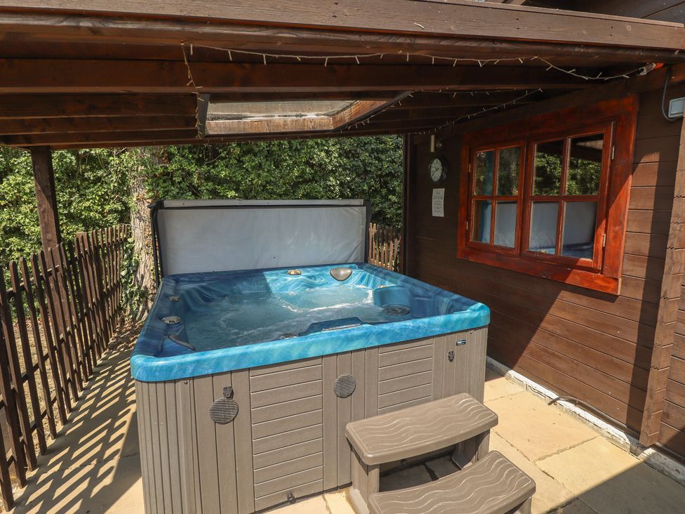 A hot tub in an outdoor area at Tythe Lodge – Hot Tub Retreat in Rural Lincolnshire | Family-Friendly Lodge Near Heckington