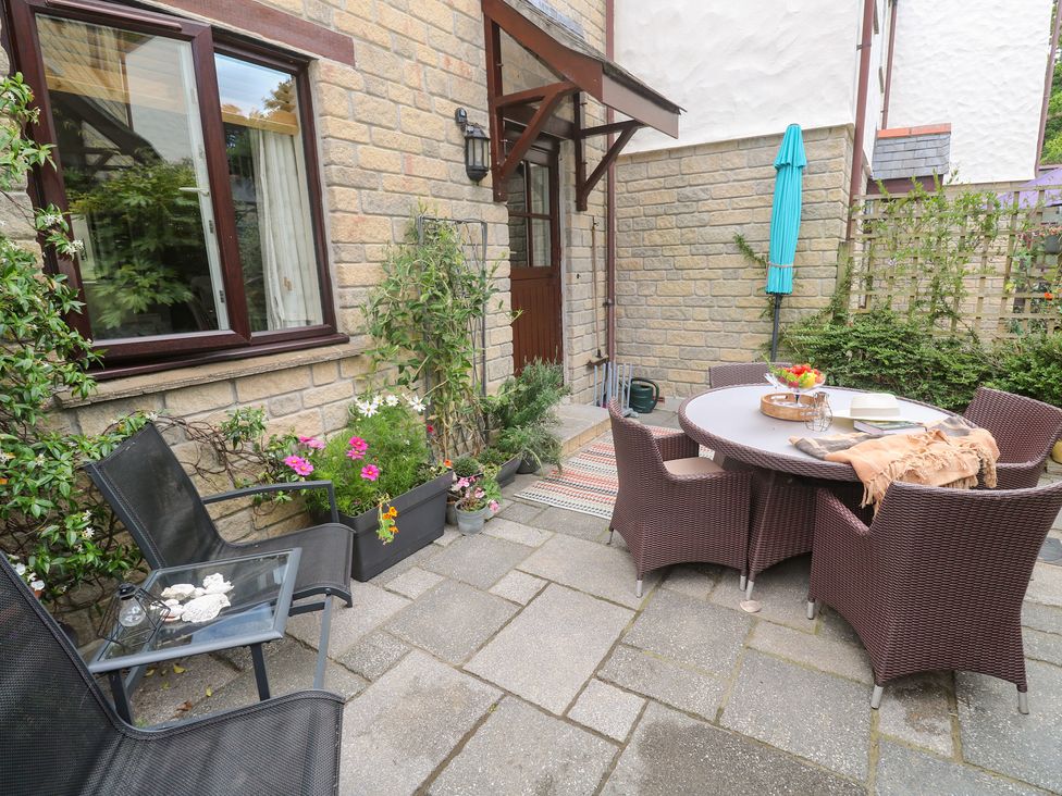 An outdoor area with a table and chairs at Tranquility in Falmouth