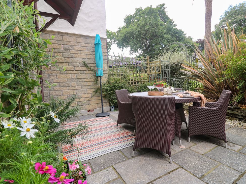 A garden with table and chairs at Tranquility in Falmouth