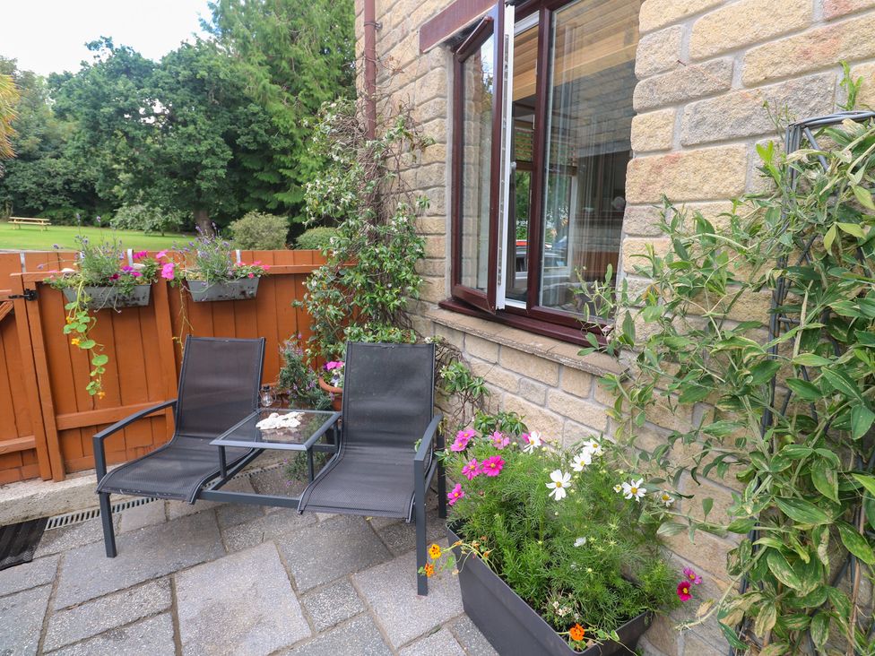 An outdoor area with chairs and a table at Tranquility in Falmouth