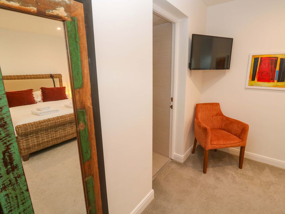A bedroom with a bed and chair at Silvermine House in Charlestown