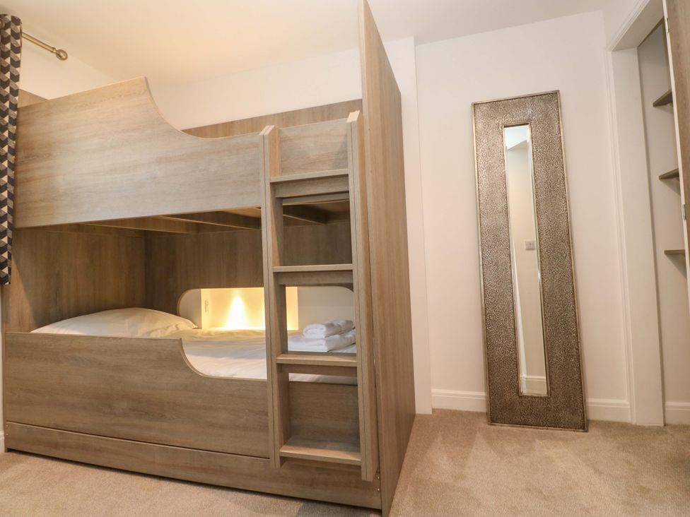 A bunk bed with a mirror in a bedroom at Silvermine House in Charlestown