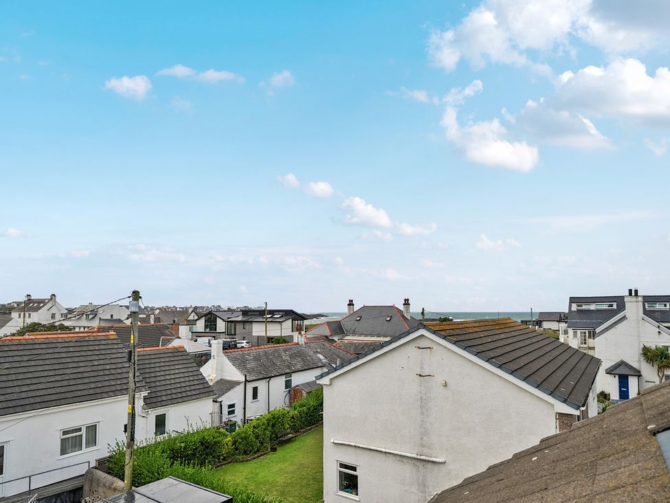 A view of houses and rooftops with a clear sky at Trearddur View in Treaddur Bay