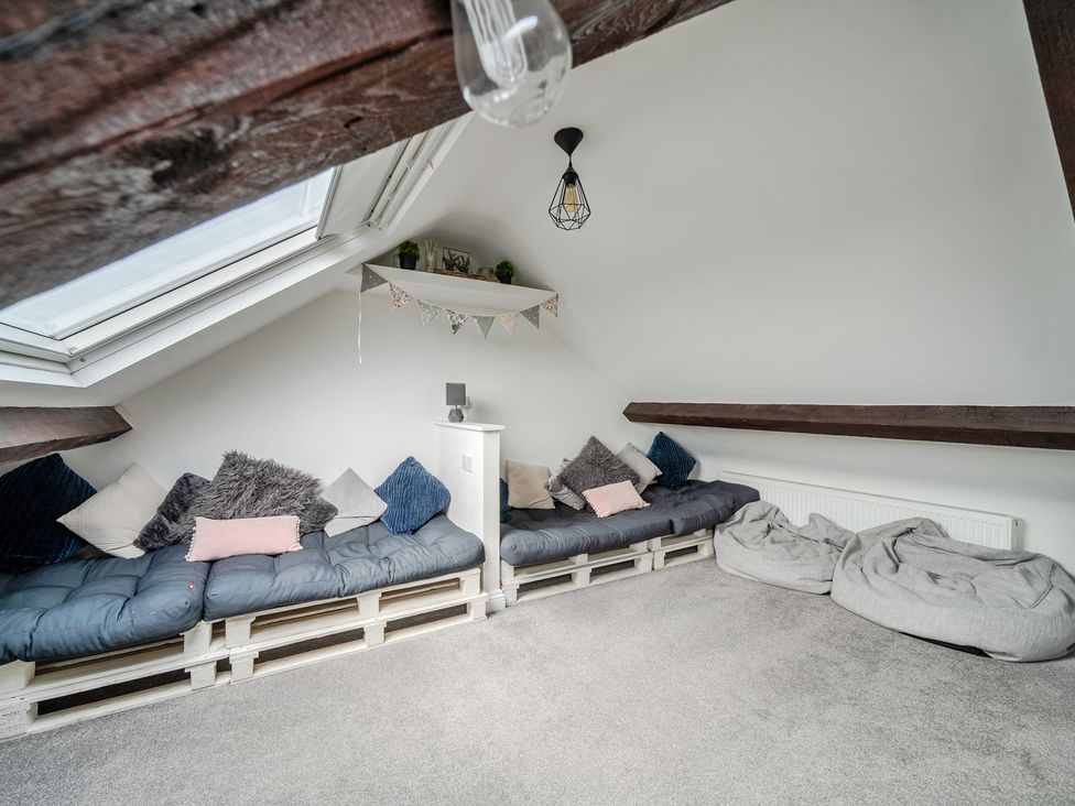 A seating area with sofas and pillows at Trearddur View in Treaddur Bay