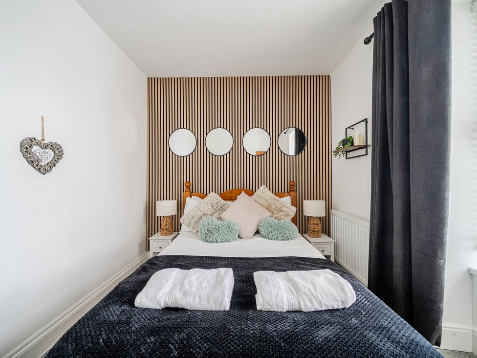 A bedroom with a bed and decorative elements at Trearddur View in Treaddur Bay