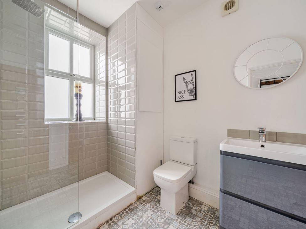 A bathroom with a shower and toilet at Trearddur View in Treaddur Bay