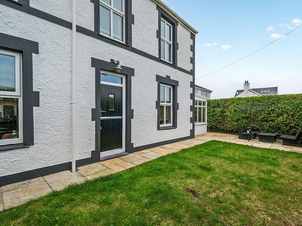 A garden area with grass and patio at Trearddur View in Treaddur Bay