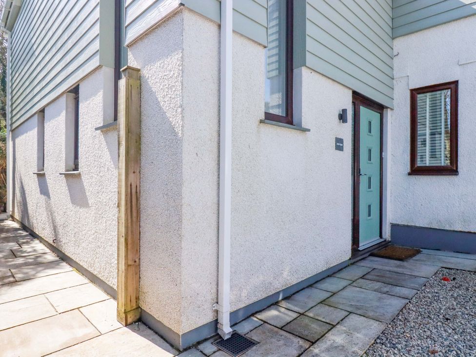 An exterior view of a house with a door and pathway at Little Pippin in Carlyon Bay near St Austell