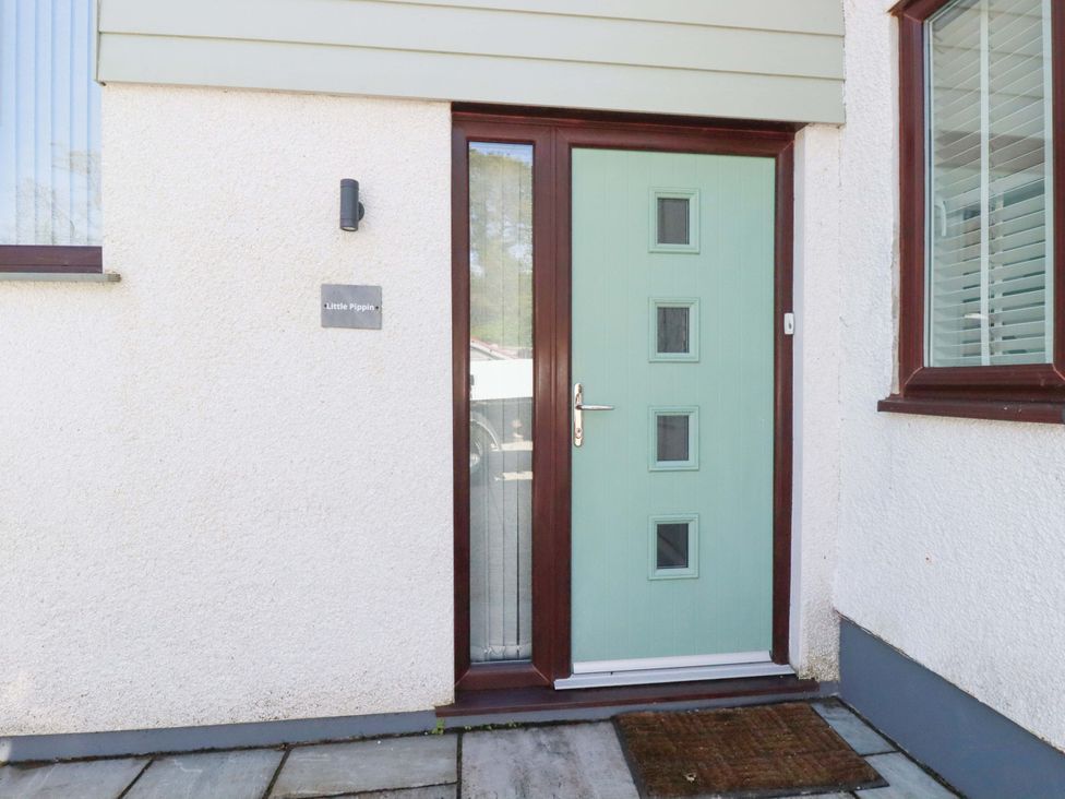 An entrance with a green door and nameplate at Little Pippin Carlyon Bay near St Austell