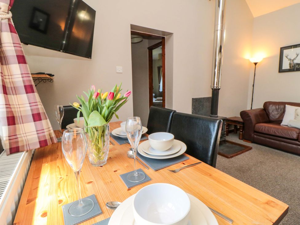 A dining area with a table set for a meal at Stable Cottage in Staintondale near Burniston