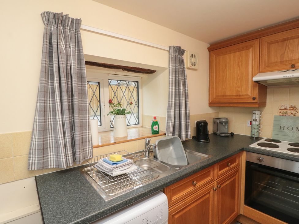 A kitchen with sink and cabinets at Foxhunter Cottage in Hawsker near Whitby and Robin Hood's Bay