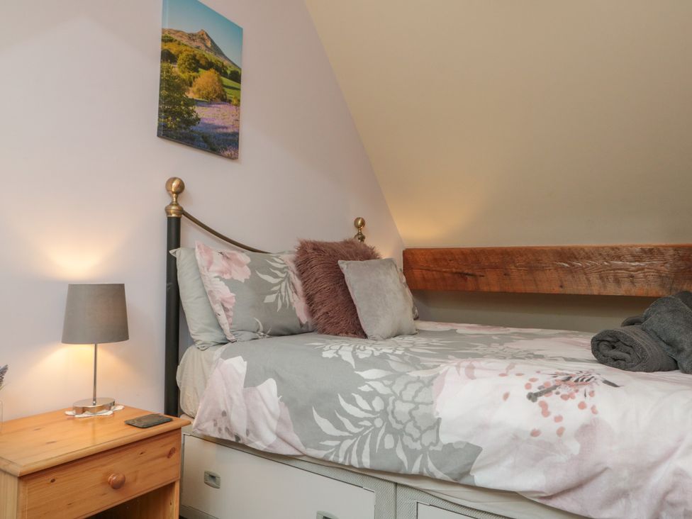 A bedroom with a bed and lamp at Foxhunter Cottage Hawsker near Whitby and Robin Hood's Bay