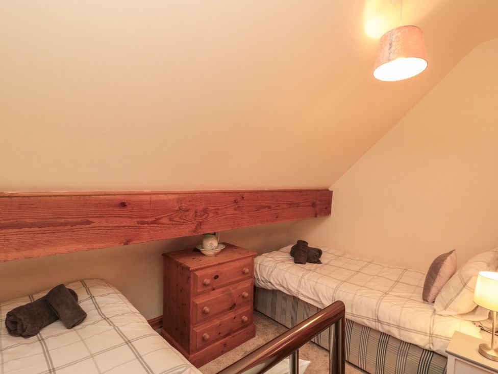 A bedroom with beds and a dresser at Foxhunter Cottage Hawsker near Whitby and Robin Hood's Bay