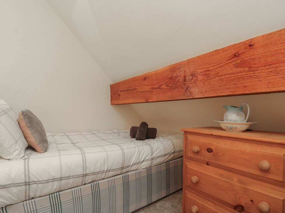 A bedroom with a bed and drawer at Foxhunter Cottage Hawsker near Whitby and Robin Hood's Bay